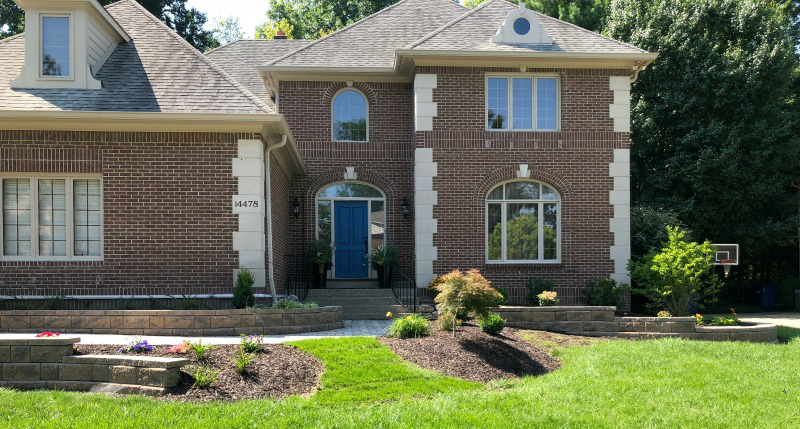 Image of brick home with lawn and professional landscape design
