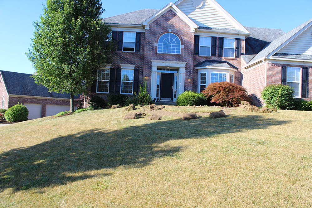 Image of a brick home on a hill