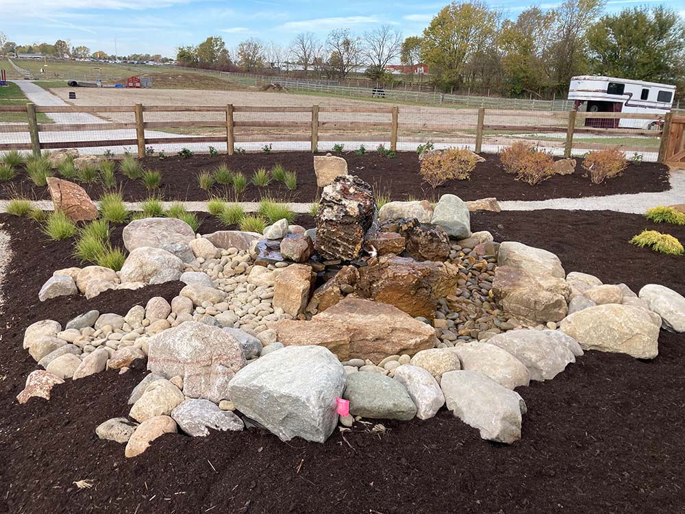 Large rock water feature on a horse farm
